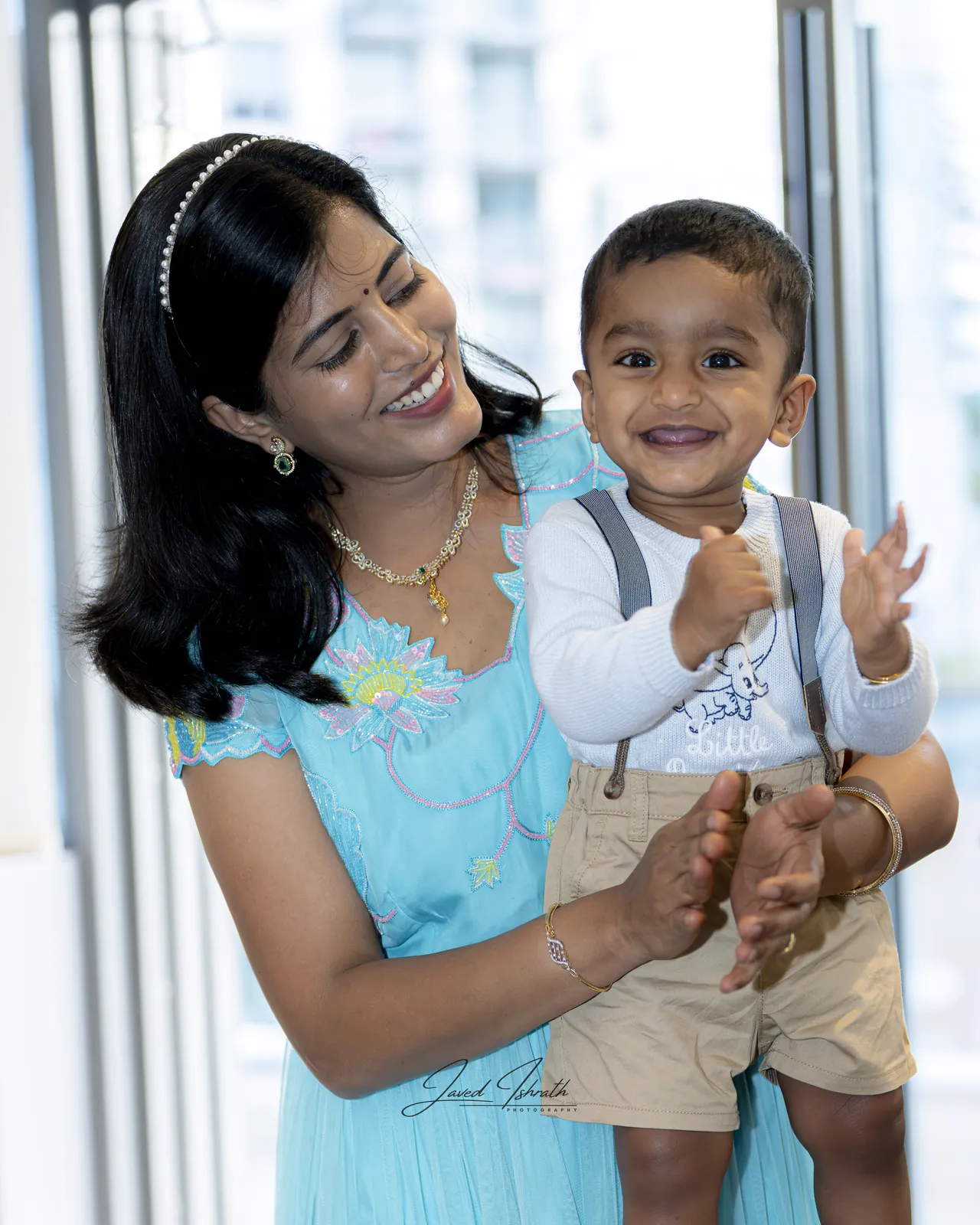 A mother and toddler laughing together