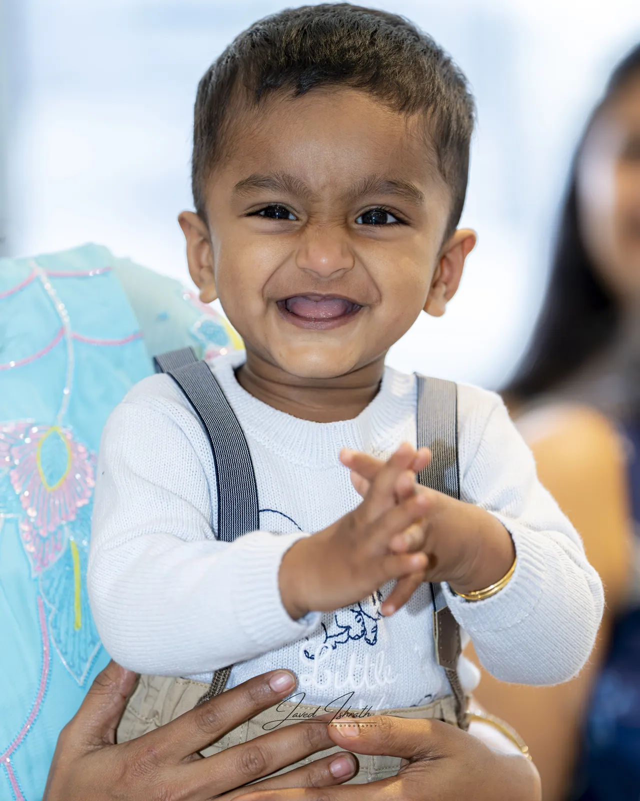 A toddler clapping and laughing