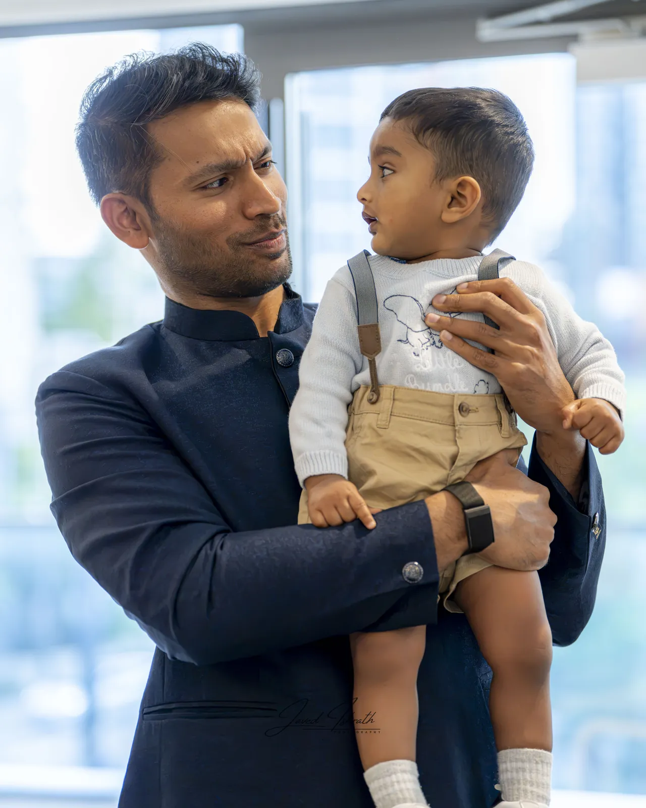 A father lifting his son at a birthday party