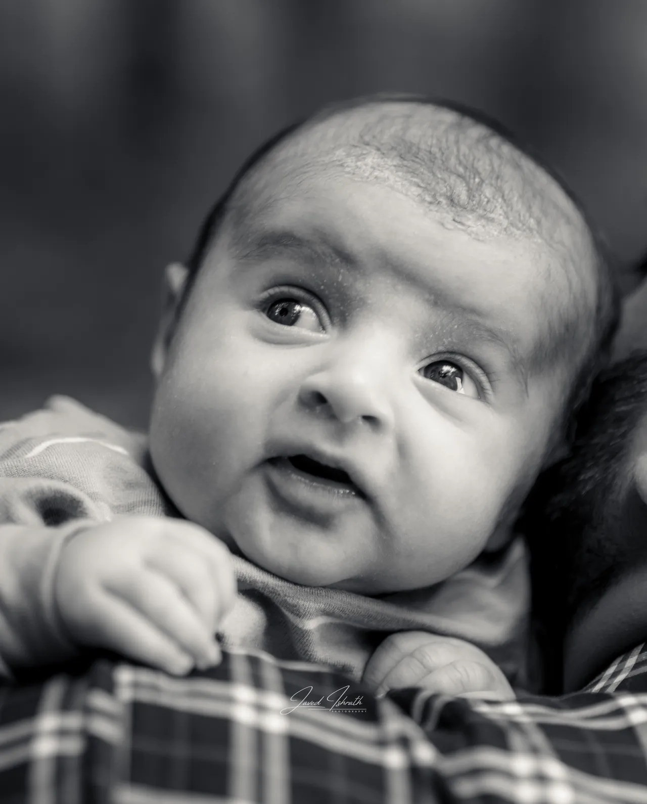 Black and white close-up of a baby looking up